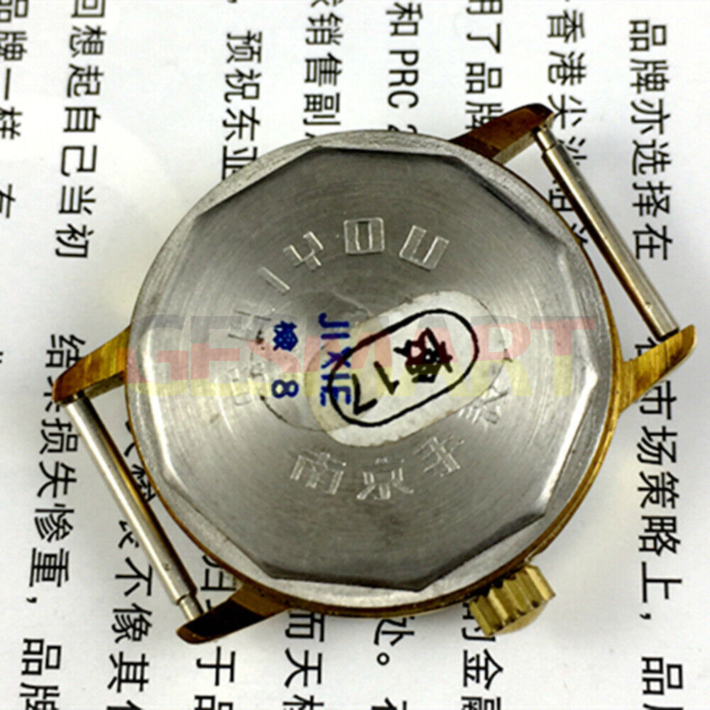 34mm manual mechanical watch with 17 jewels, golden dial, and round gold case.