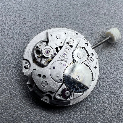 Disassembled Swiss RONDA MATIC 1217-21 manual winding watch movement showcasing intricate components.