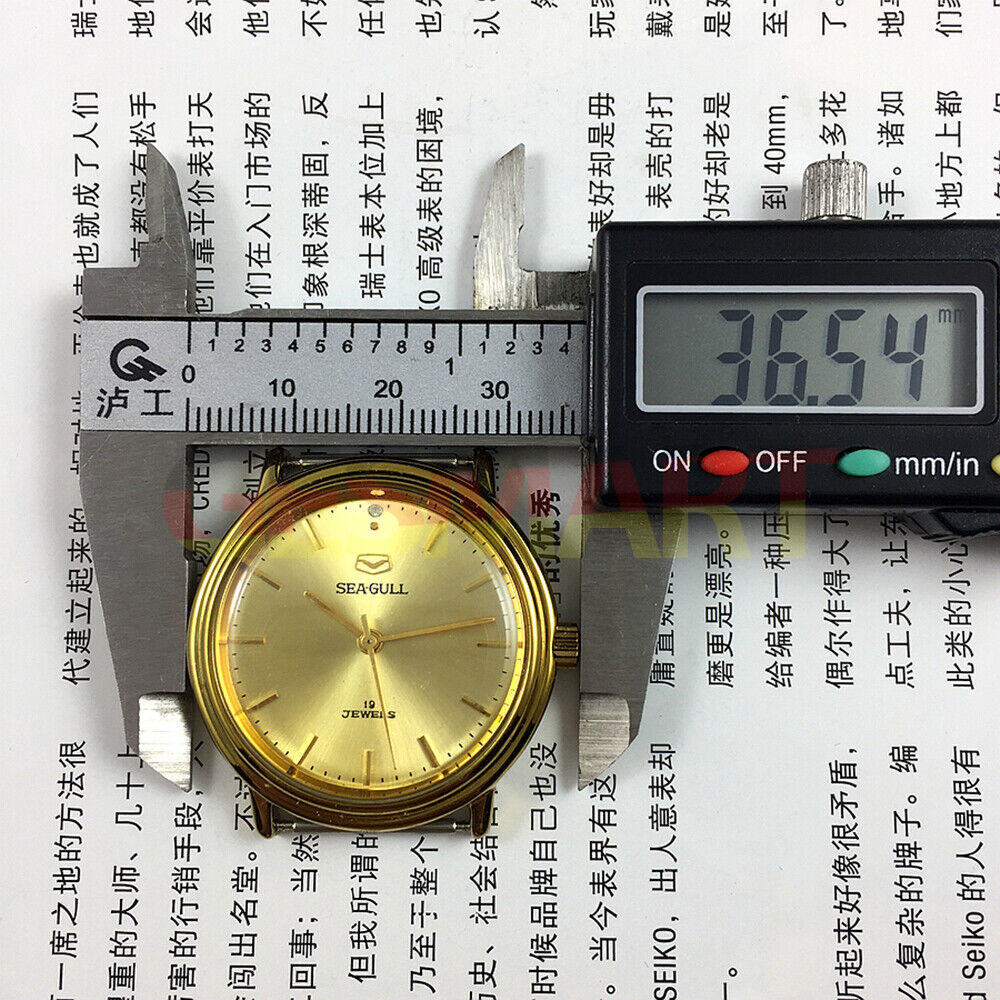 35mm Tianjin Seagull watch with golden case, round dial, manual mechanical movement, classic style.