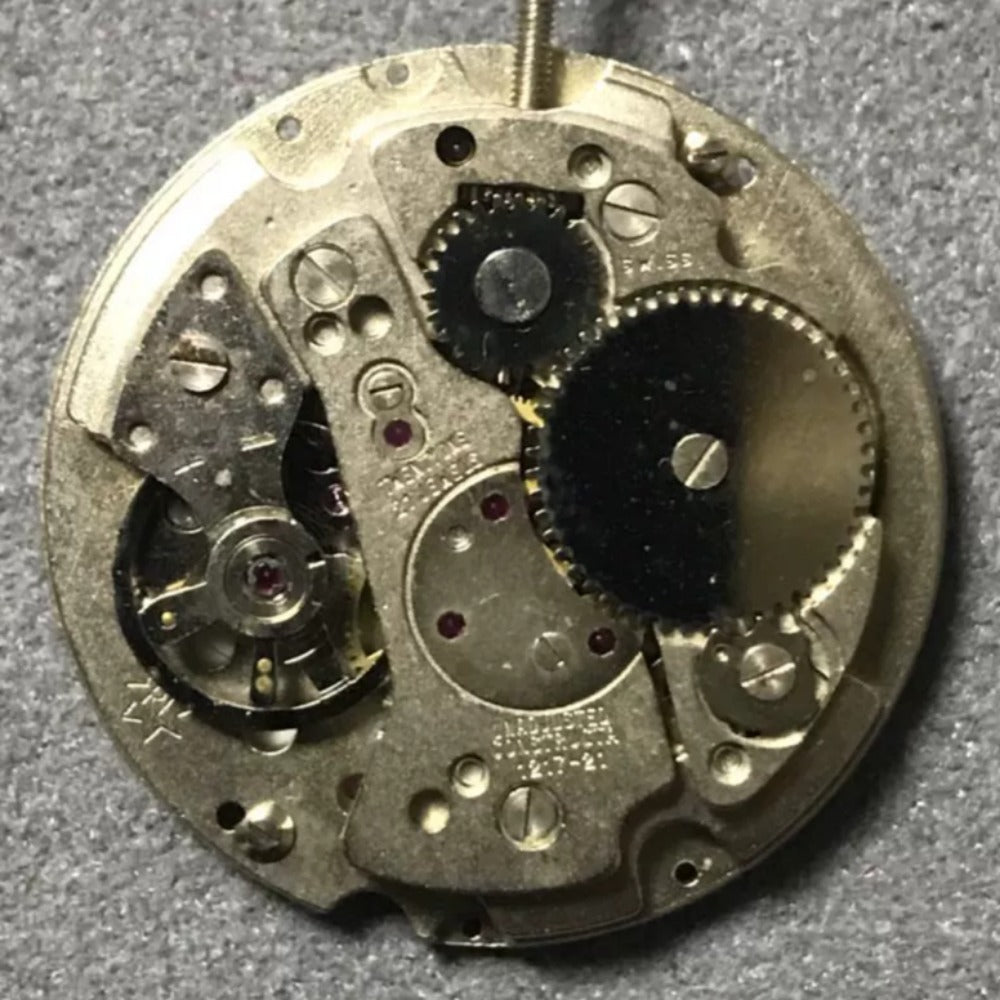 Disassembled Swiss Made RONDA MATIC 1217-21 manual winding watch movement parts for precise repair.
