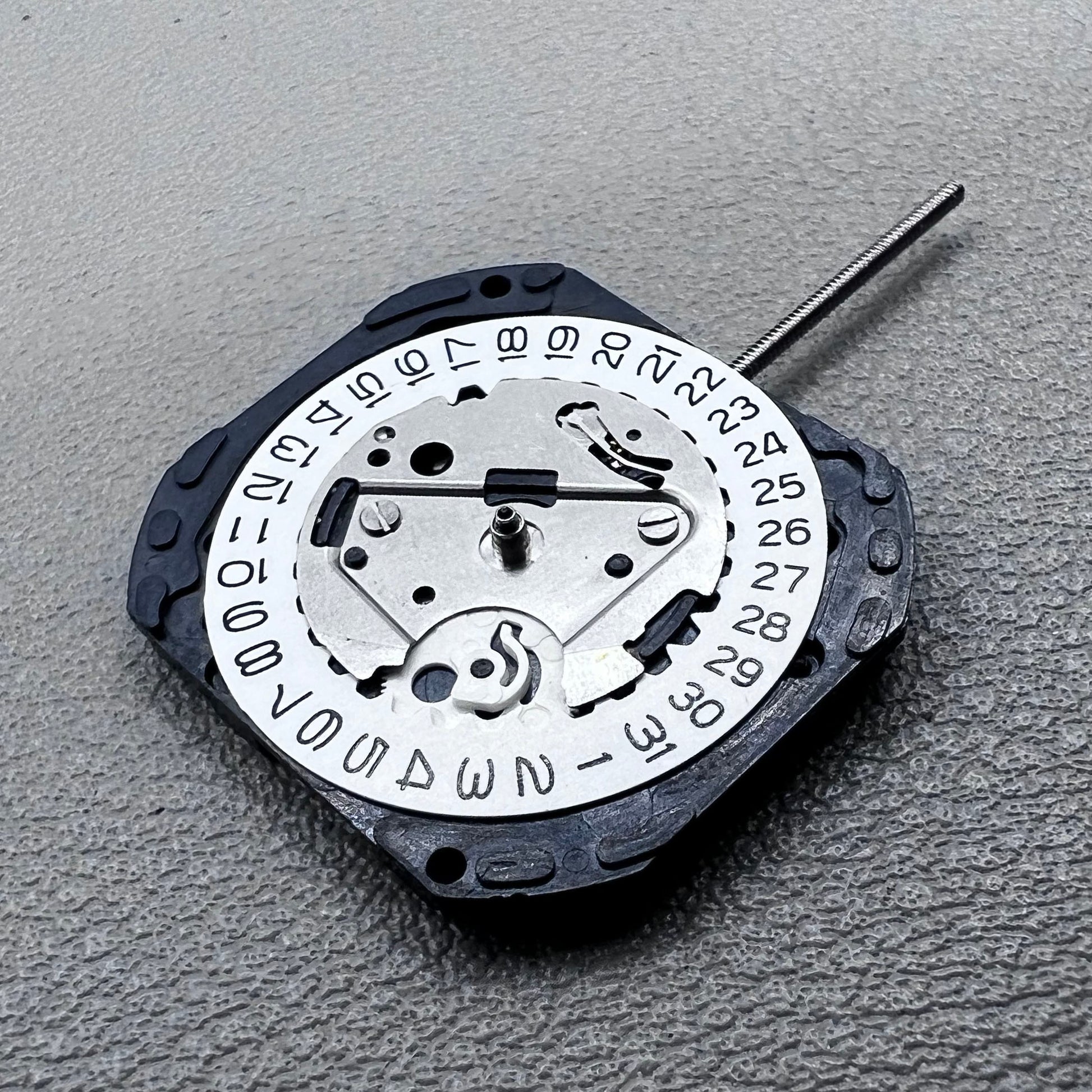 Japan VX22 quartz watch movement with date at 3 o'clock, white disk replacement for precision.