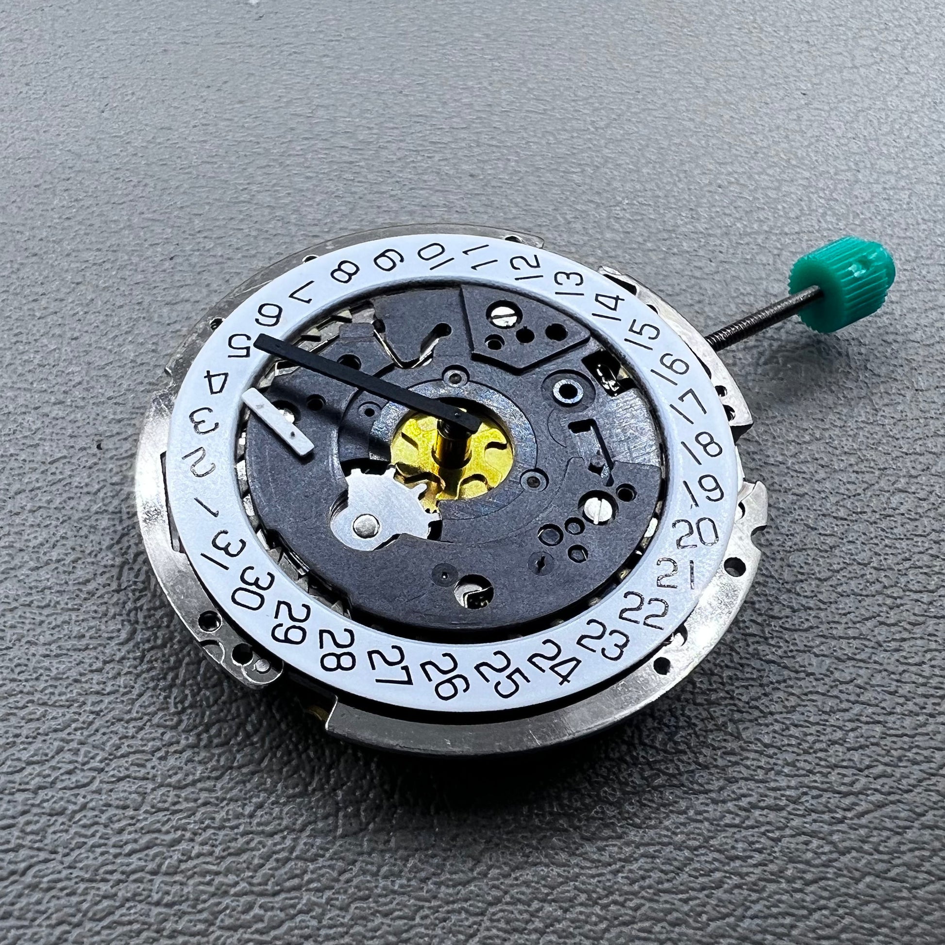 Swiss ISA 8172 silver plated quartz watch movement with stem, precise timekeeping for watch repair and assembly.
