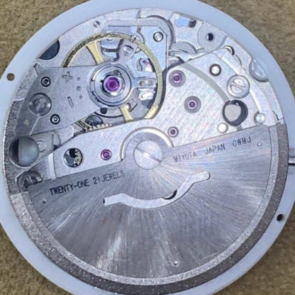 Close-up of New Japan Made Miyota 8285 mechanical watch movement with Arabic font date disk
