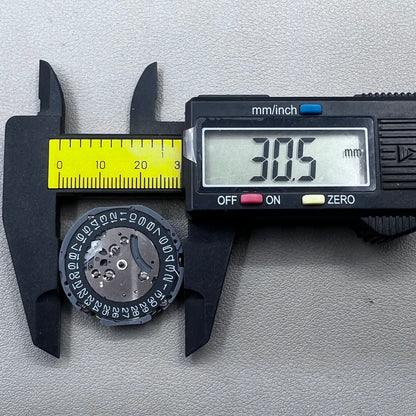 Japan Seiko VK63 quartz watch movement with black disk and white font for precise timekeeping.