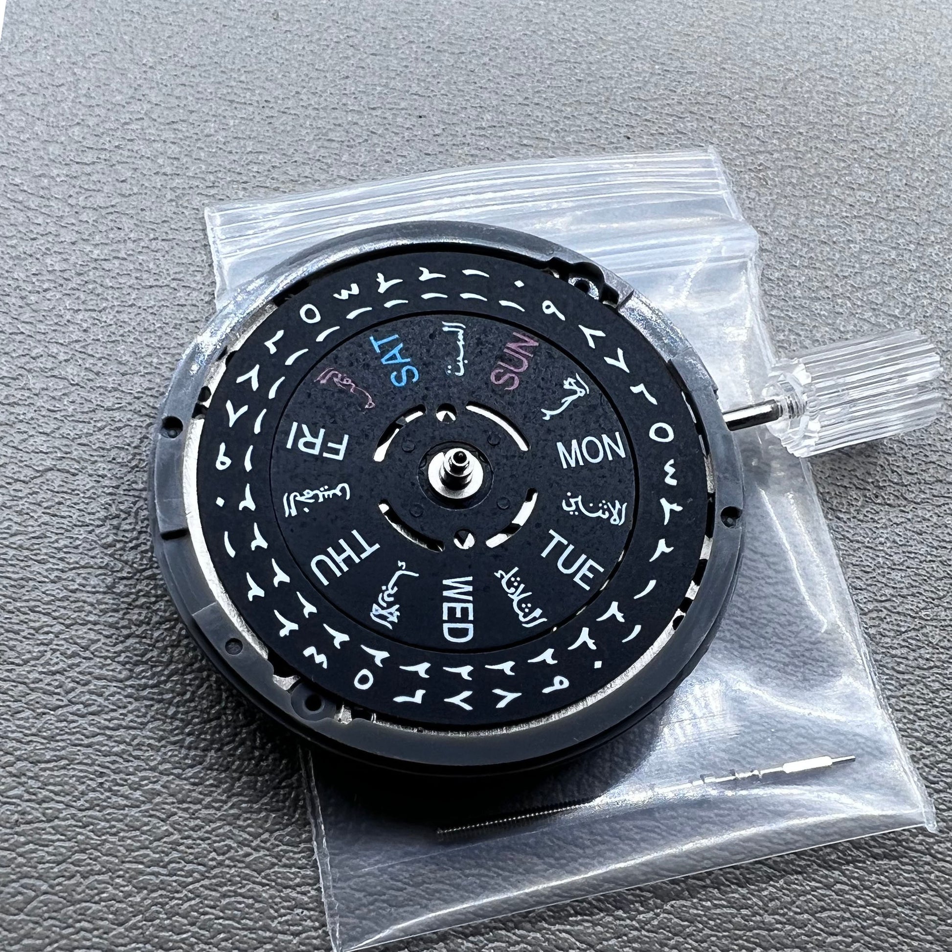 Seiko NH36 watch movement with black dial, Arabic numerals, date display, crown at 3:00 position