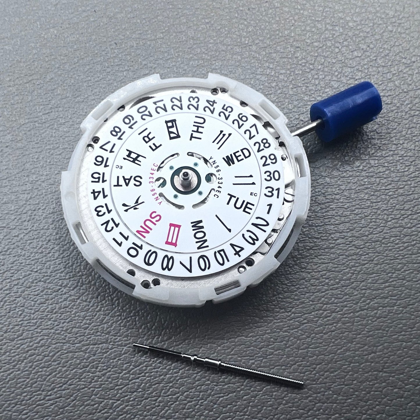 Japan Epson YN56 mechanical watch movement showing date and day display at 3 o'clock, precise and reliable.