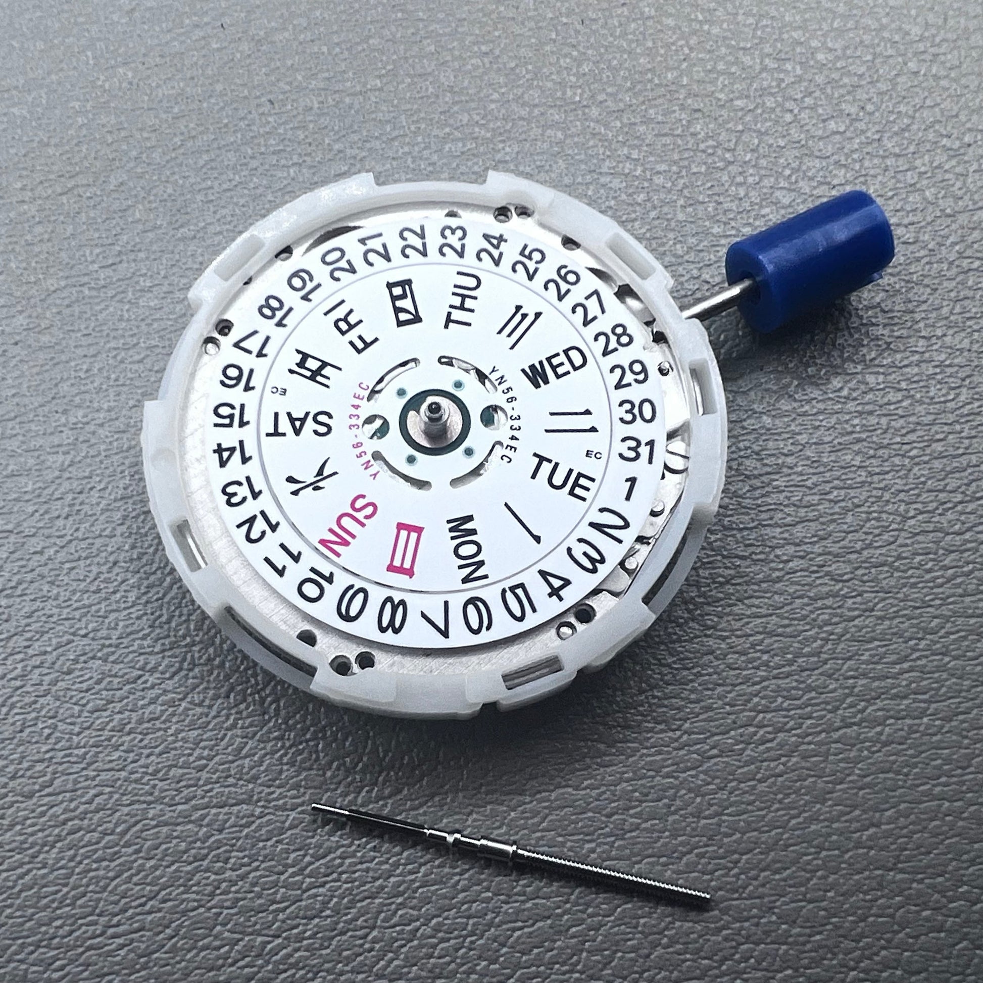 Japan Epson YN56 mechanical watch movement showing date and day display at 3 o'clock, precise and reliable.