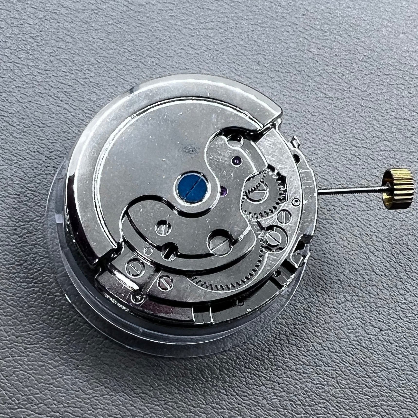 Silver Asian Dandong automatic watch with mechanical movement, date and week indicators, moon phase display.