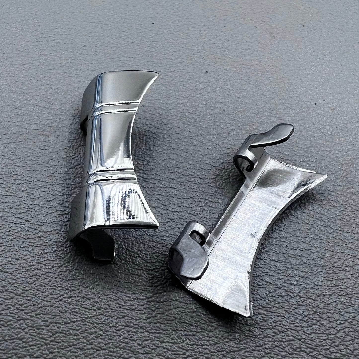 Set of 2 silver steel curved end links with spring bars for 24x12mm watch bands, enhancing bracelet fit.