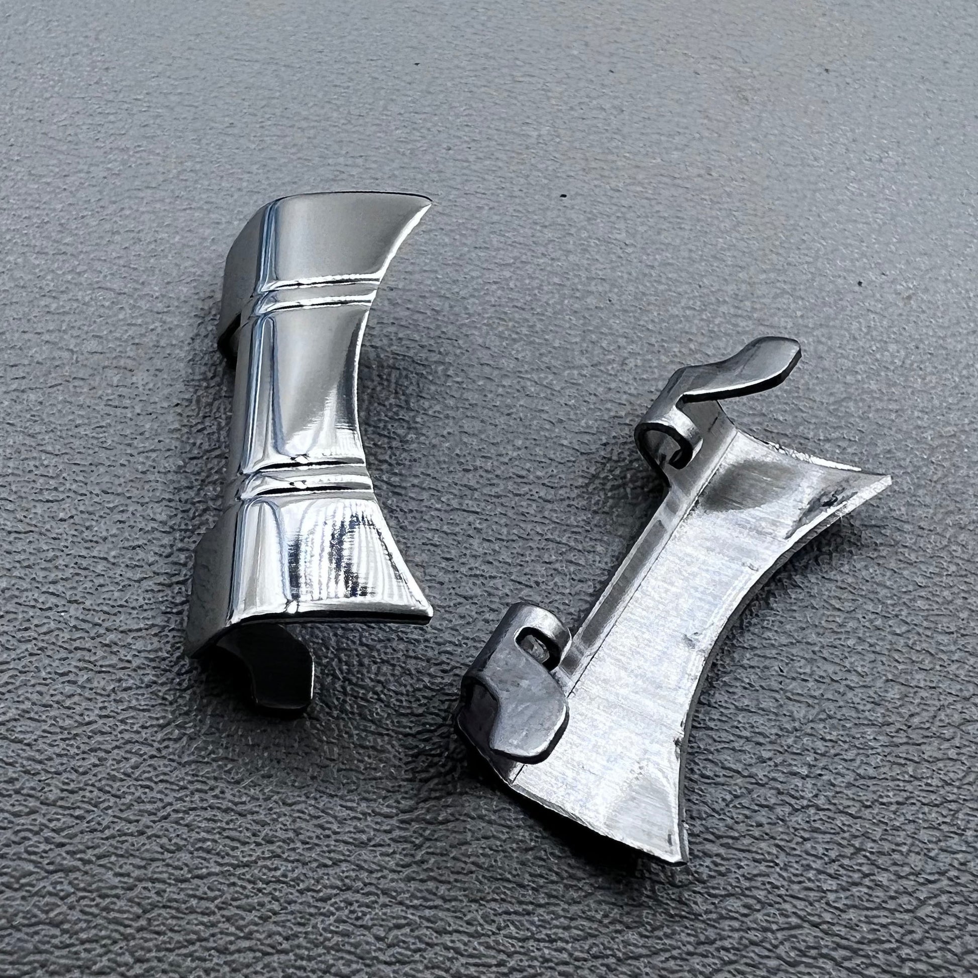Set of 2 silver steel curved end links with spring bars for 24x12mm watch bands, enhancing bracelet fit.