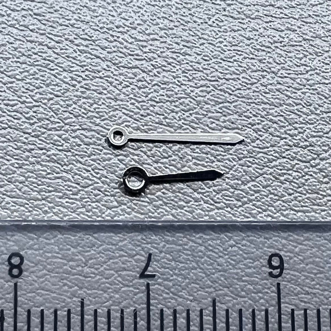 Set of 2 silver 10x7mm watch hands for Ronda 763/762/751/1062/1063 movements, perfect for repairs.