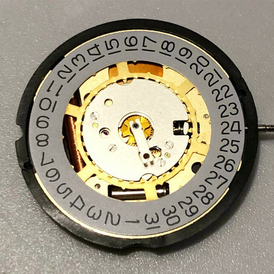 Swiss Made Ronda 715 golden quartz watch movement with date display at 3 and 6 o'clock.