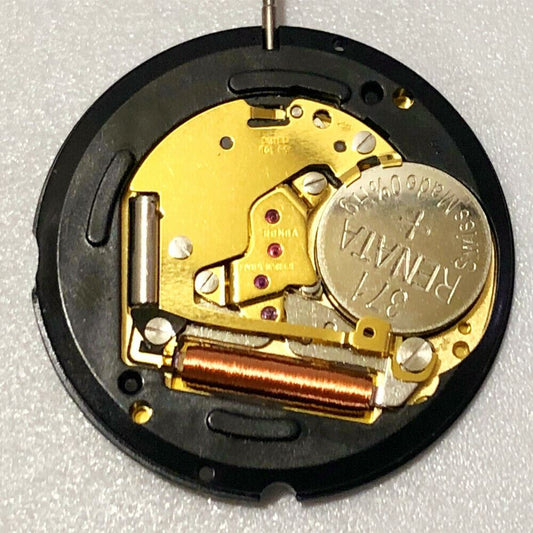 Swiss Made Ronda 715 golden quartz watch movement with date display at 3 and 6 o'clock.