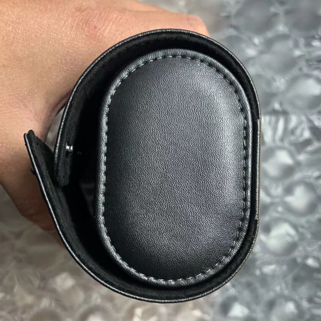 Black leather travel watch case with 3 slots, portable roll organizer for secure watch storage.