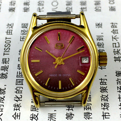 Tianjin Seagull purple dial ladies watch with gold accents, manual mechanical movement for elegant style.