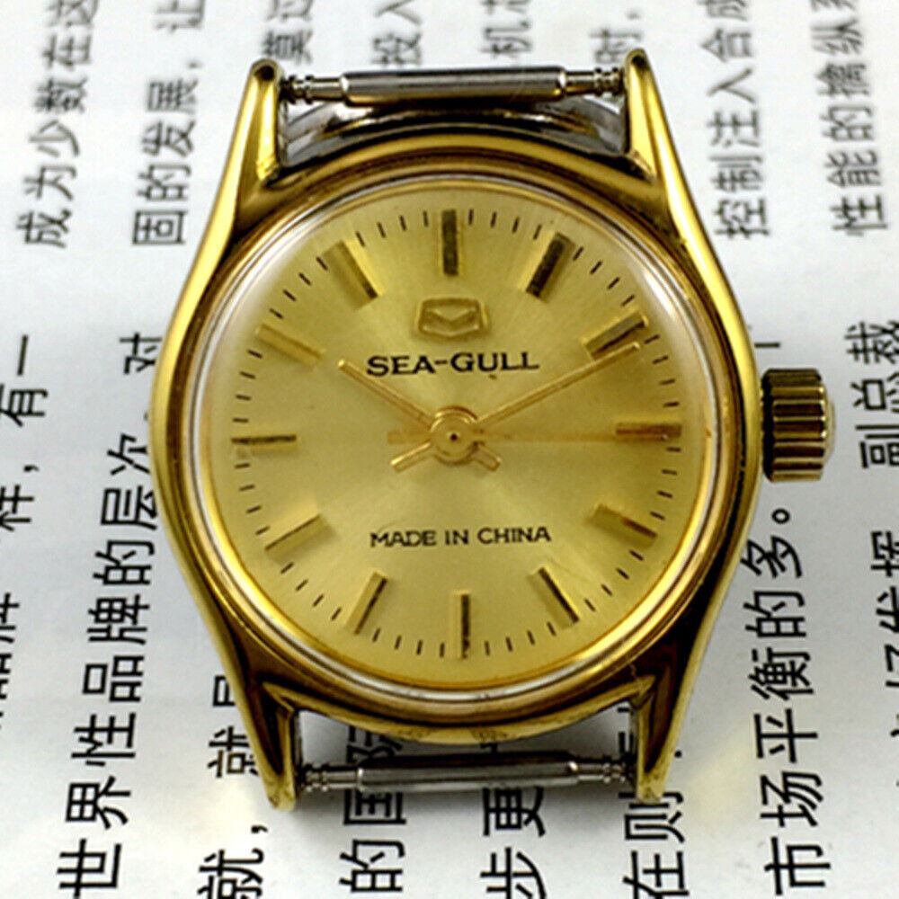 Round gold-tone case ladies watch with golden nail markers, manual mechanical movement by Tianjin Seagull.
