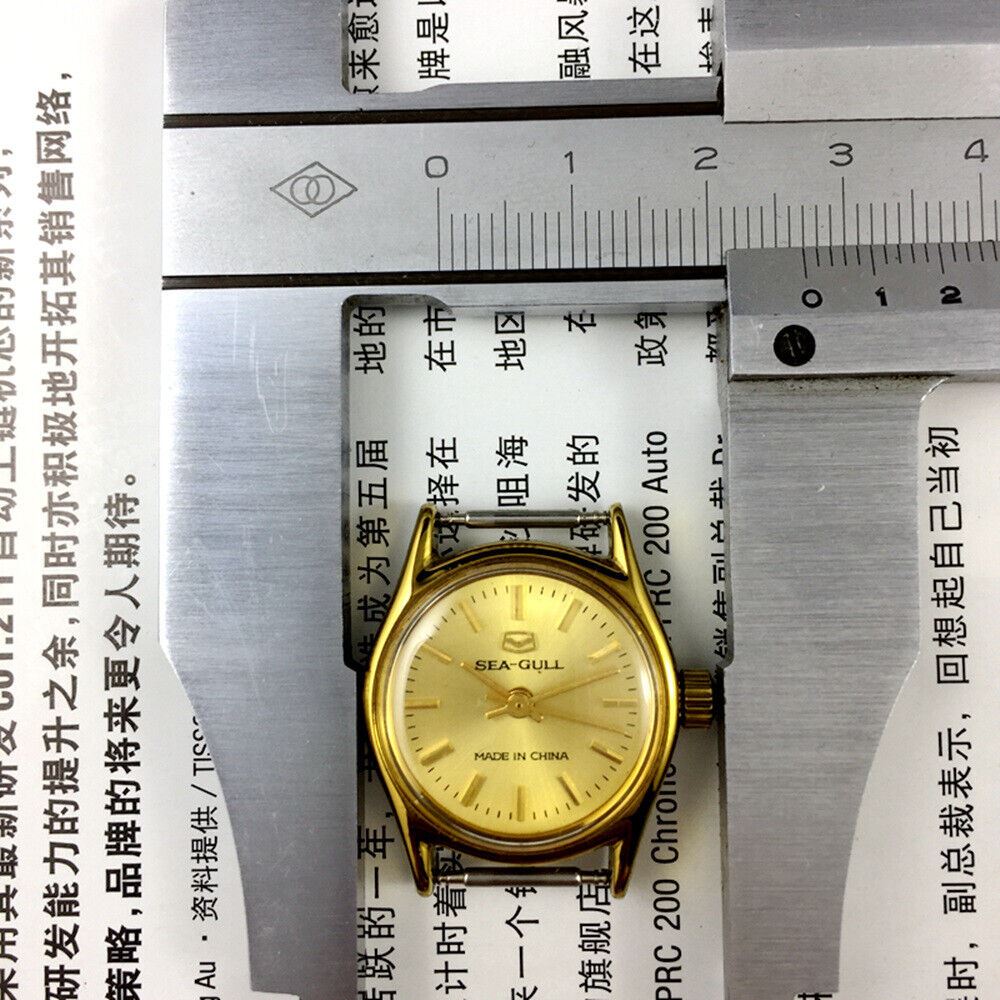 Round gold-tone ladies watch with golden nail markers, manual mechanical movement by Tianjin Seagull, elegant design.