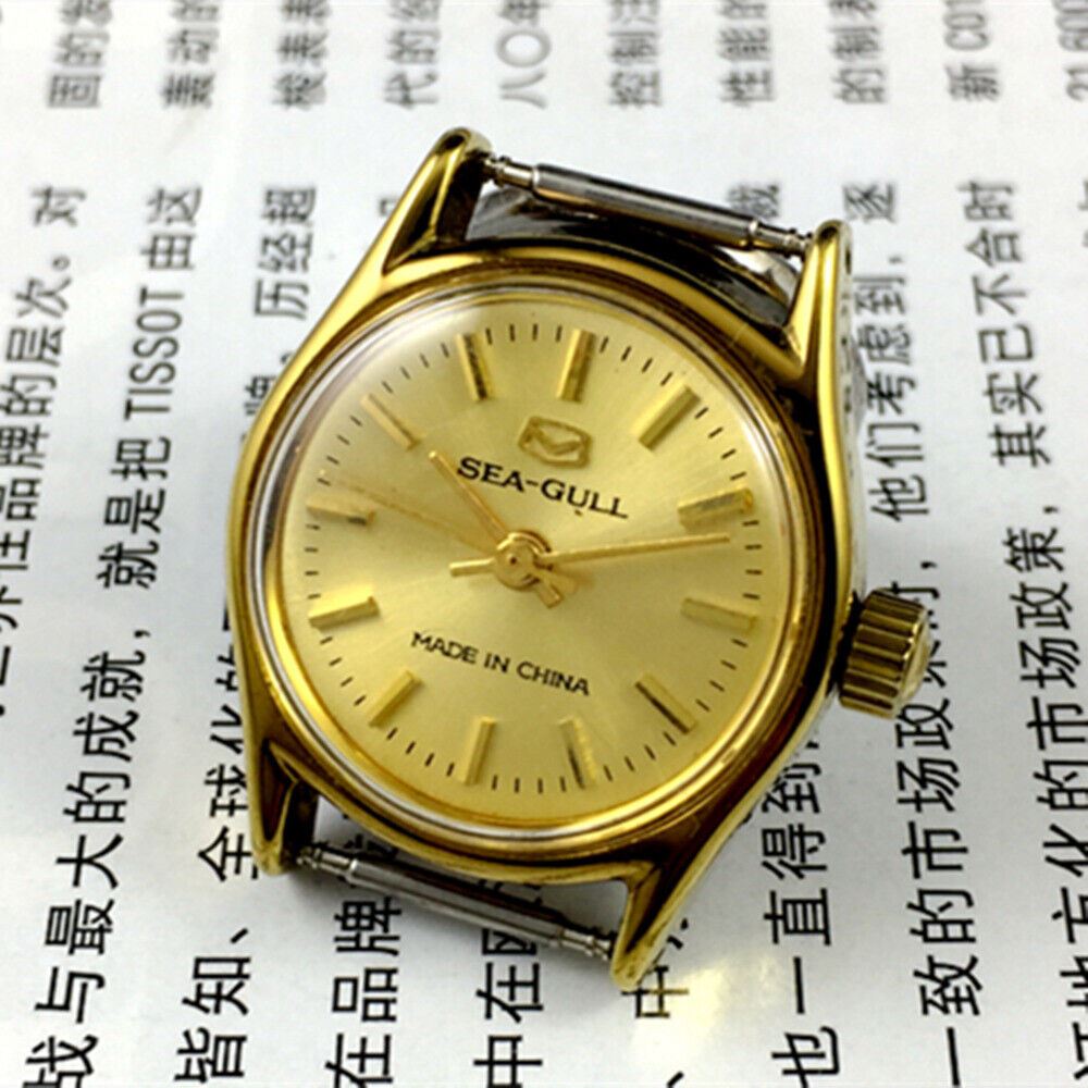 Round gold-tone ladies watch with golden nail markers, manual mechanical movement by Tianjin Seagull.