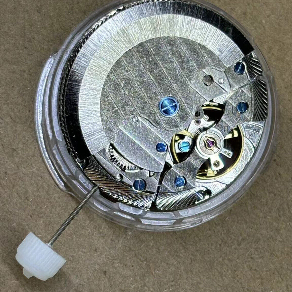 Shanghai watch accessory with automatic mechanical movement, big date at 12, bare flywheel, elegant design.