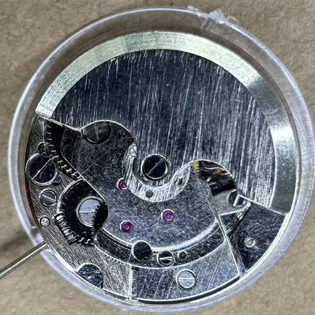 China Made 7120 watch accessory with automatic mechanical movement, moon phase at 6, and exposed balance wheel design.