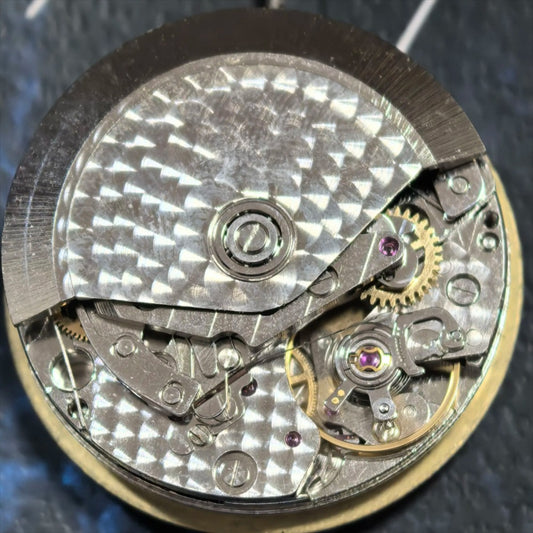 Dandong 7750 mechanical watch movement showing date at 3 o'clock and small second at 9 o'clock.