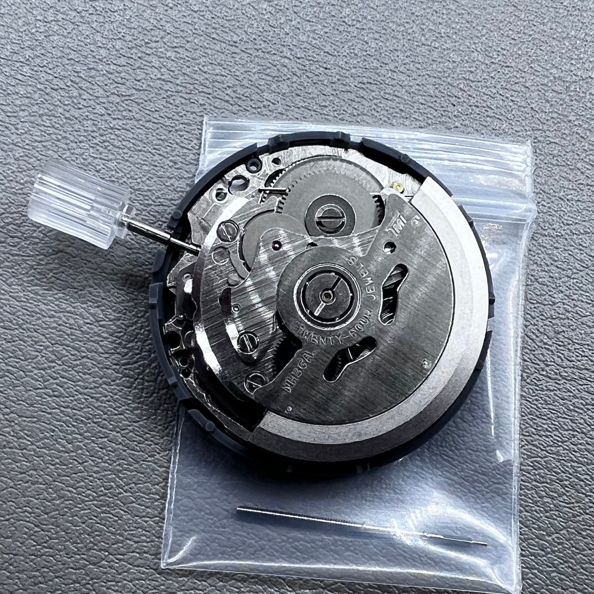 Seiko NH36 watch movement with black dial, Arabic numerals, date display, crown at 3:00 position