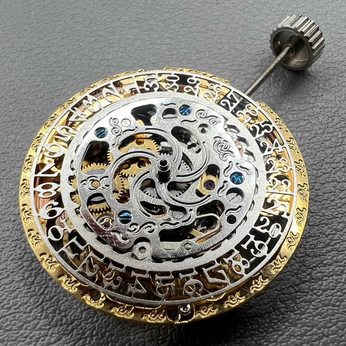 Golden Hangzhou 2189 mechanical calendar watch movement showcasing intricate hollow design and precise craftsmanship.