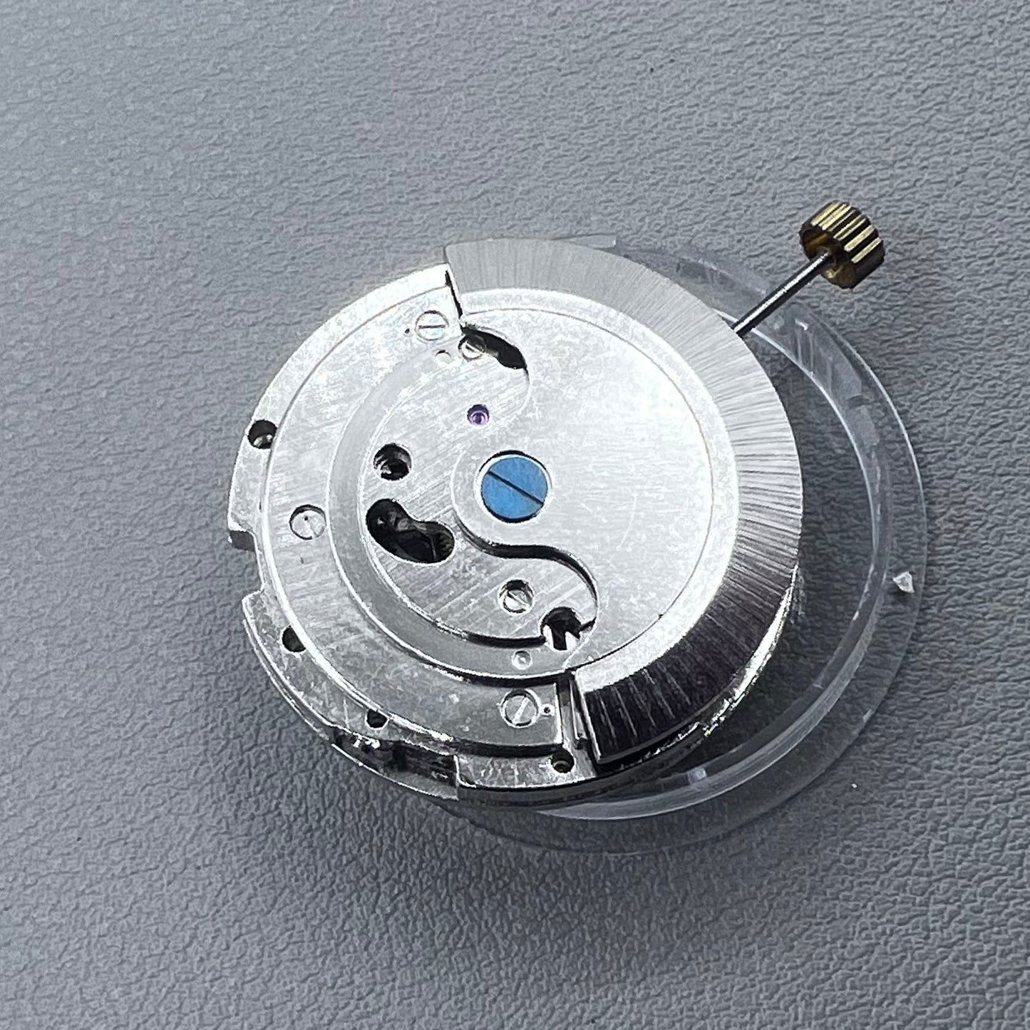 China multifunctional automatic watch with mechanical movement, moon phase at 12 o?clock, and visible flywheel detail