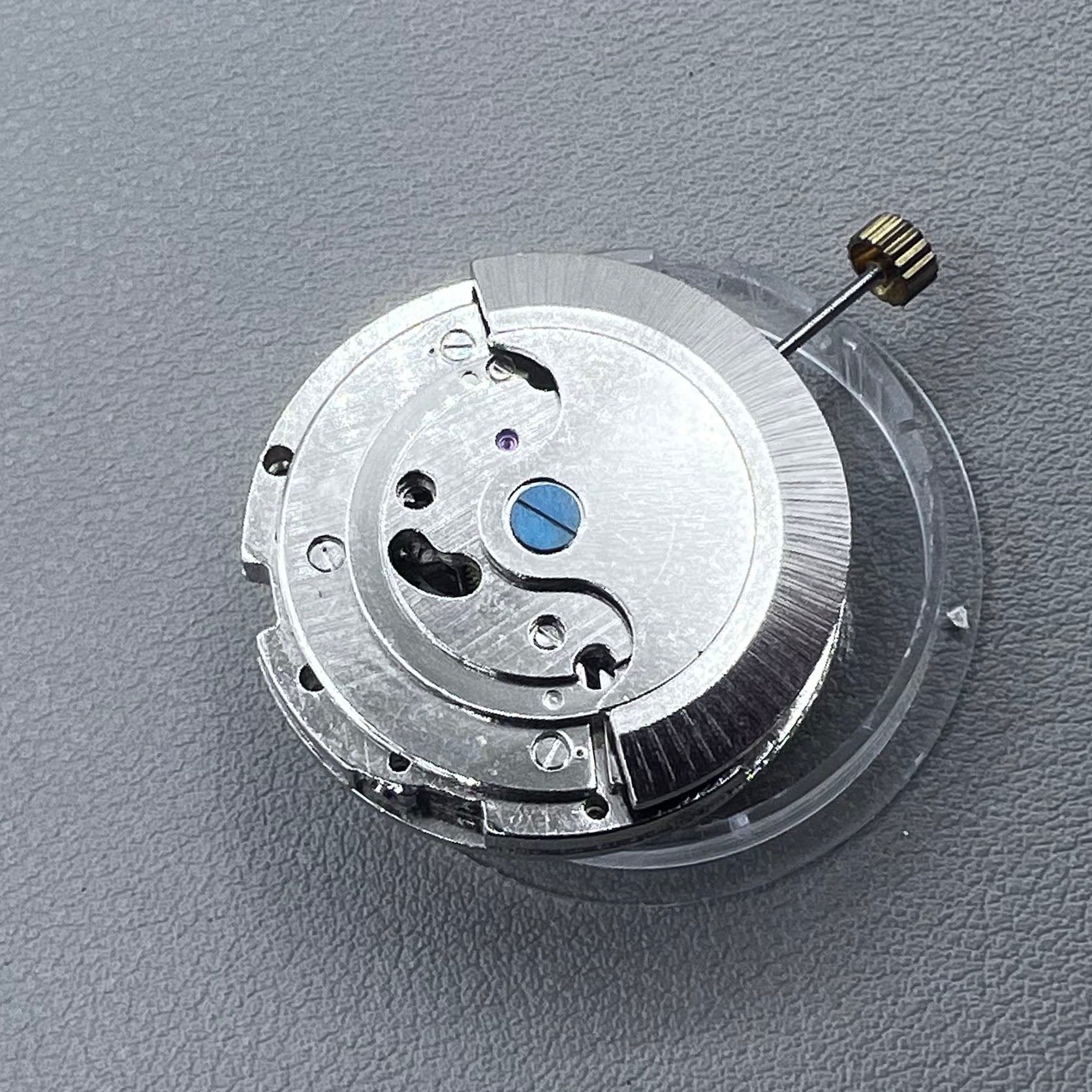 China multifunctional automatic watch with mechanical movement, moon phase at 12 o?clock, and visible flywheel detail