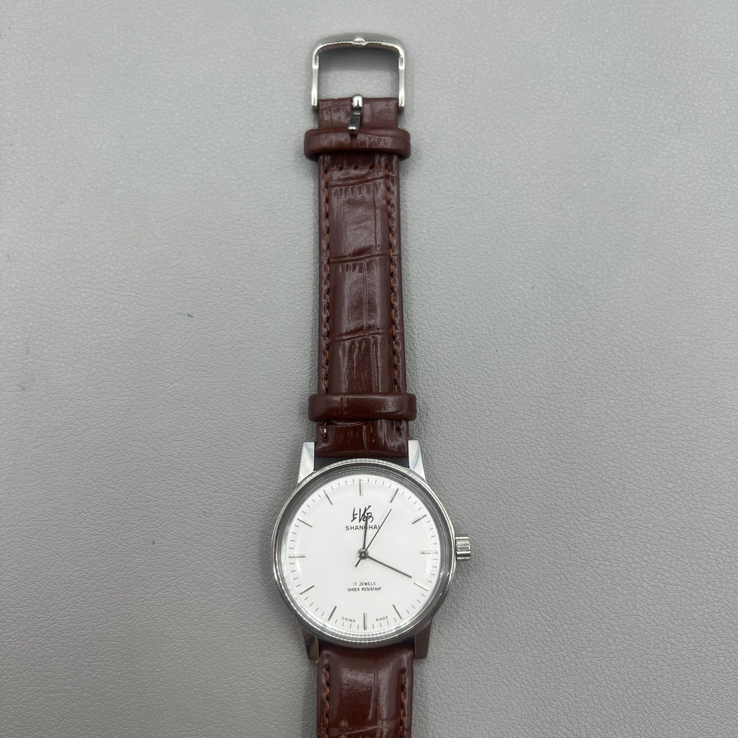 Shanghai 36mm 8120 manual mechanical watch with white dial, brown strap, 17 jewels precision craftsmanship.