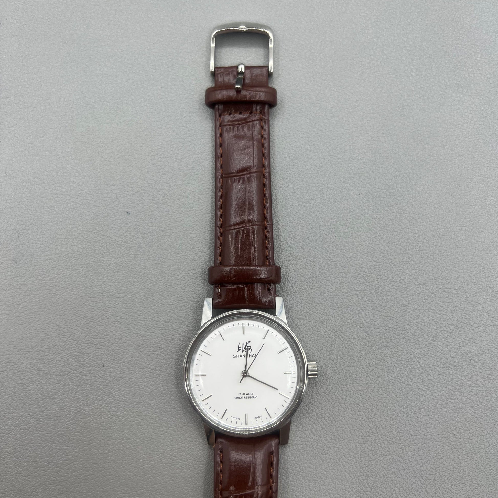 Shanghai 36mm 8120 manual mechanical watch with white dial, brown strap, 17 jewels precision craftsmanship.