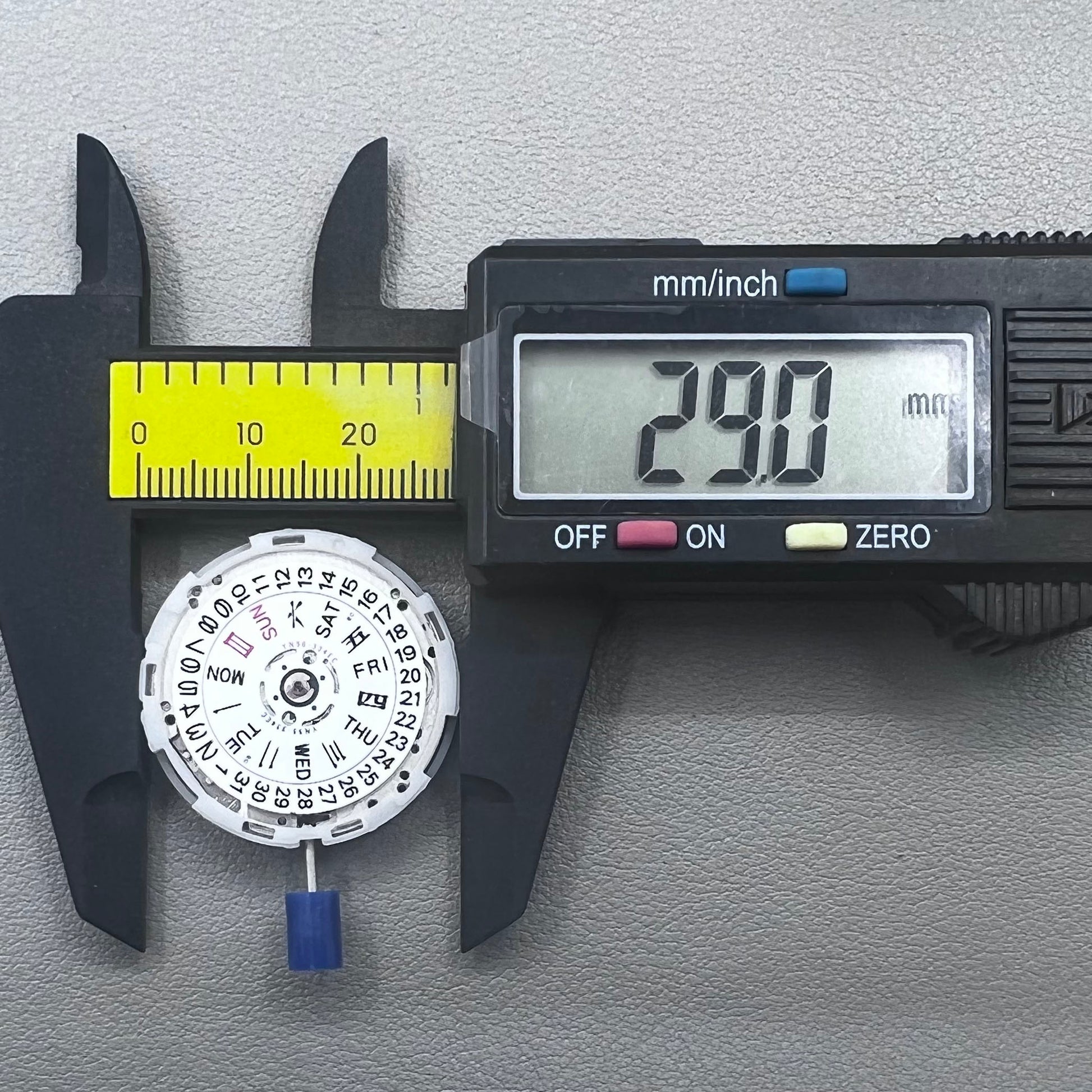 Japan Epson YN56 mechanical watch movement showing date and day display at 3 o'clock, precise and reliable.