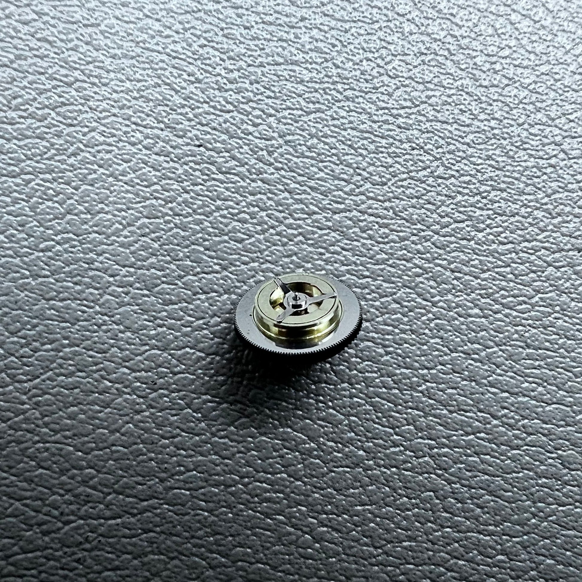 Black counting wheel for ETA C01.211 watch movement, precision replacement part for watch repair.