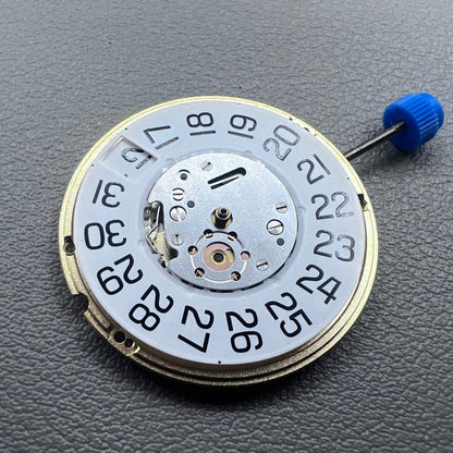 Swiss ETA F06.161 quartz watch movement with white dial, 3 hands, and date at 3 o?clock for precise timekeeping.