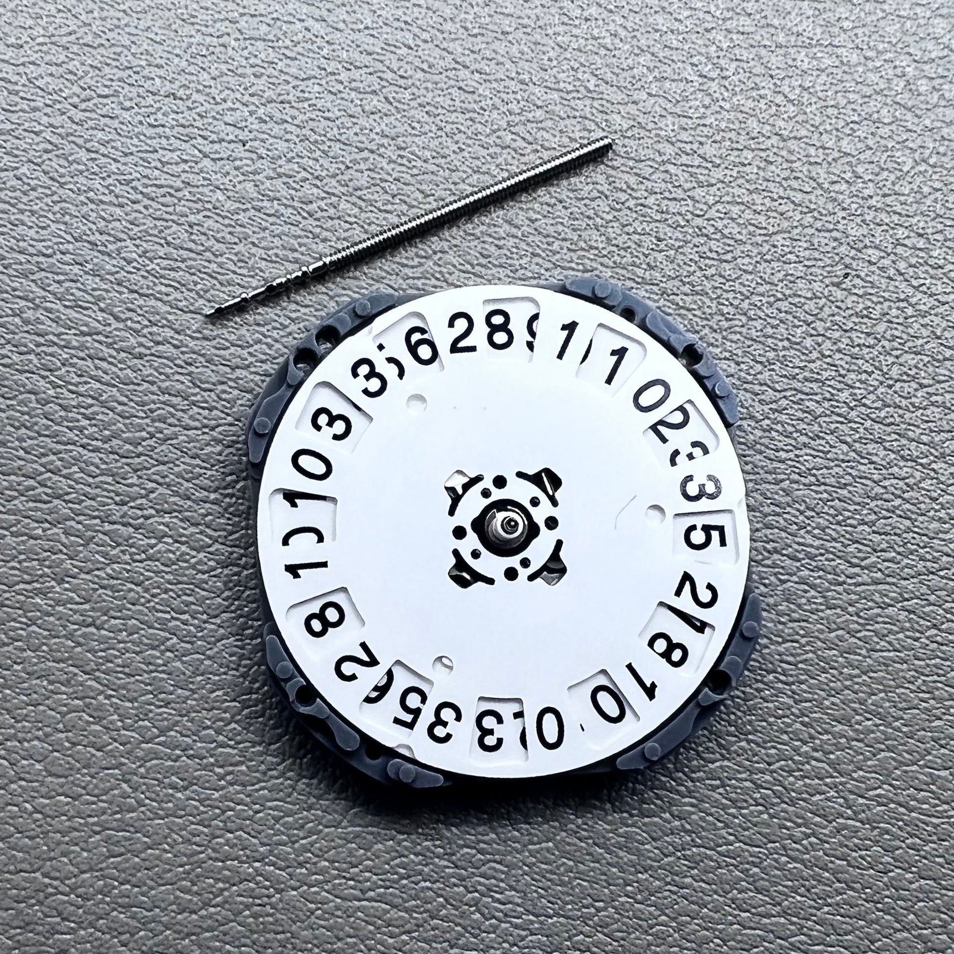 Japan Hattori VJ76B quartz watch movement with date display at 12 o'clock position, precise timekeeping.