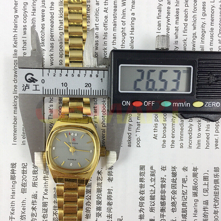 TAISHAN elegant lady watch with 19 jewels, golden case, and imitation diamond hour markers for stylish wear.