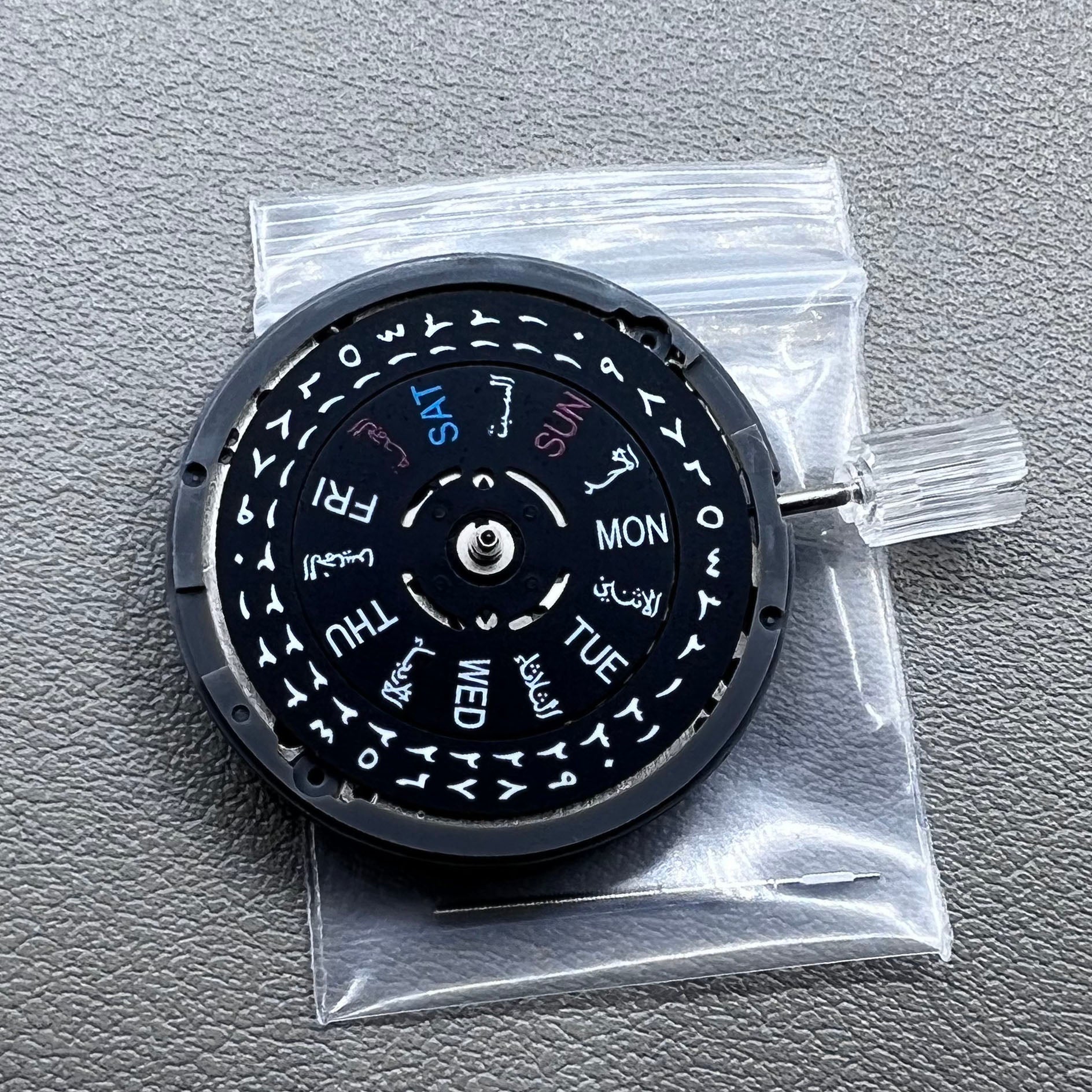Seiko NH36 watch movement with black dial, Arabic numerals, date display, crown at 3:00 position