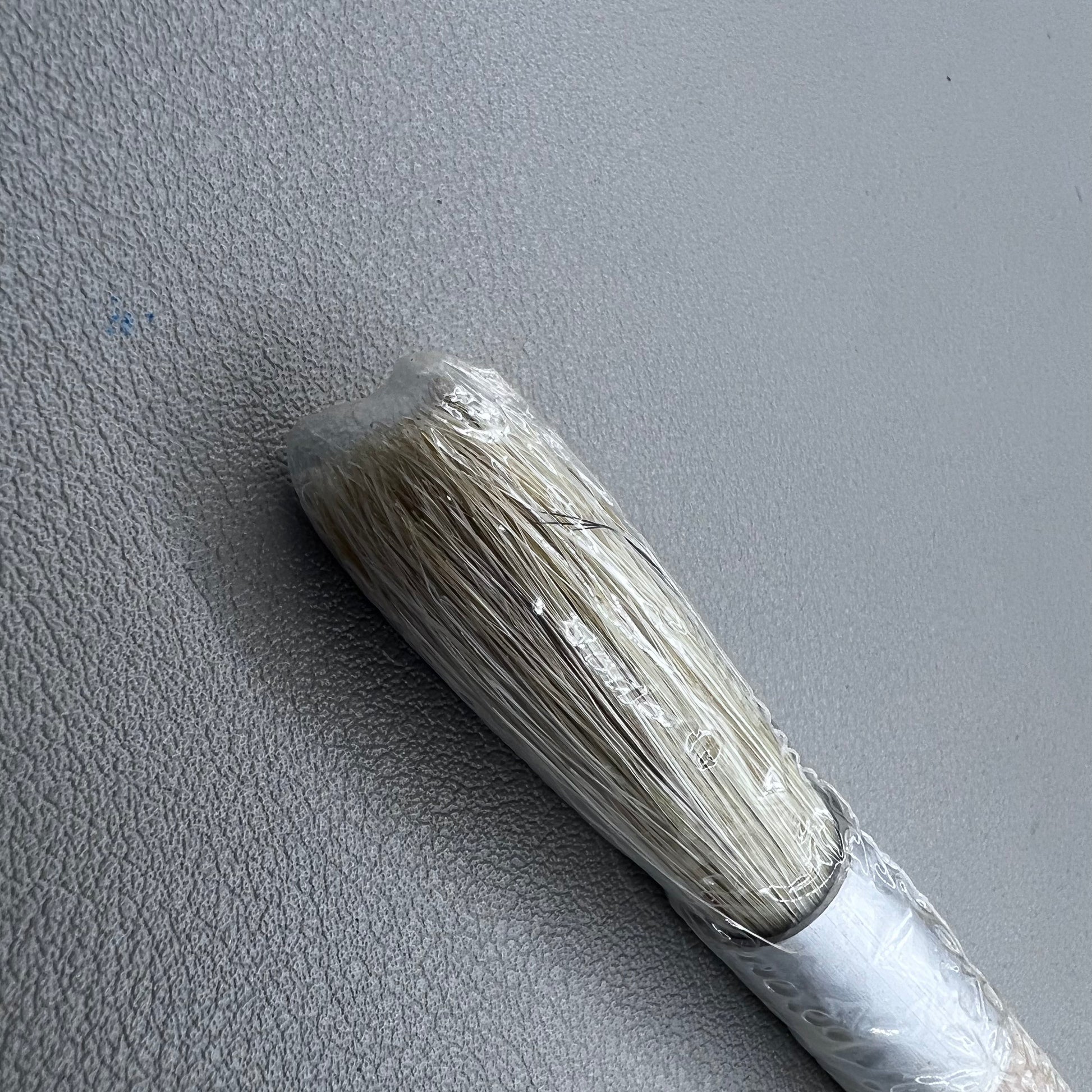 Swiss Bergeon 1307-02 white bristle brush for delicate watch cleaning and maintenance.