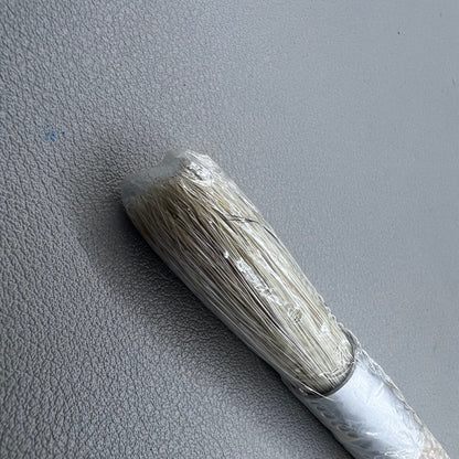 Swiss Bergeon 1307-02 white bristle brush for delicate watch cleaning and maintenance.