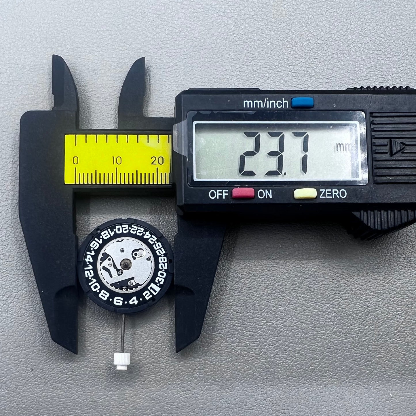Swiss ISA 2330 quartz watch movement with black font date at 6 o'clock, precise 3-hand accessory.