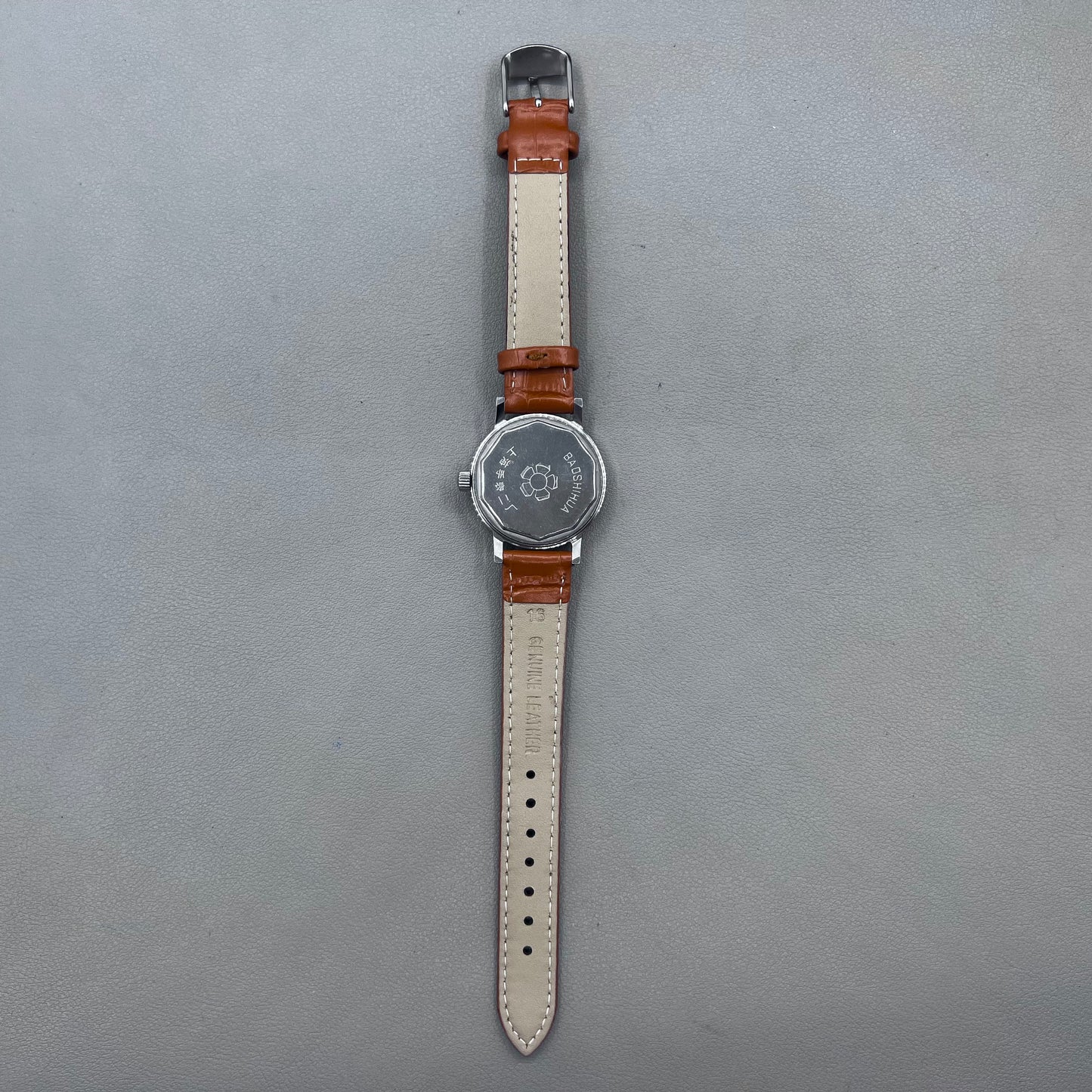 Light brown Shanghai manual mechanical watch with single calendar, 17 jewels, shock-resistant design for durability.