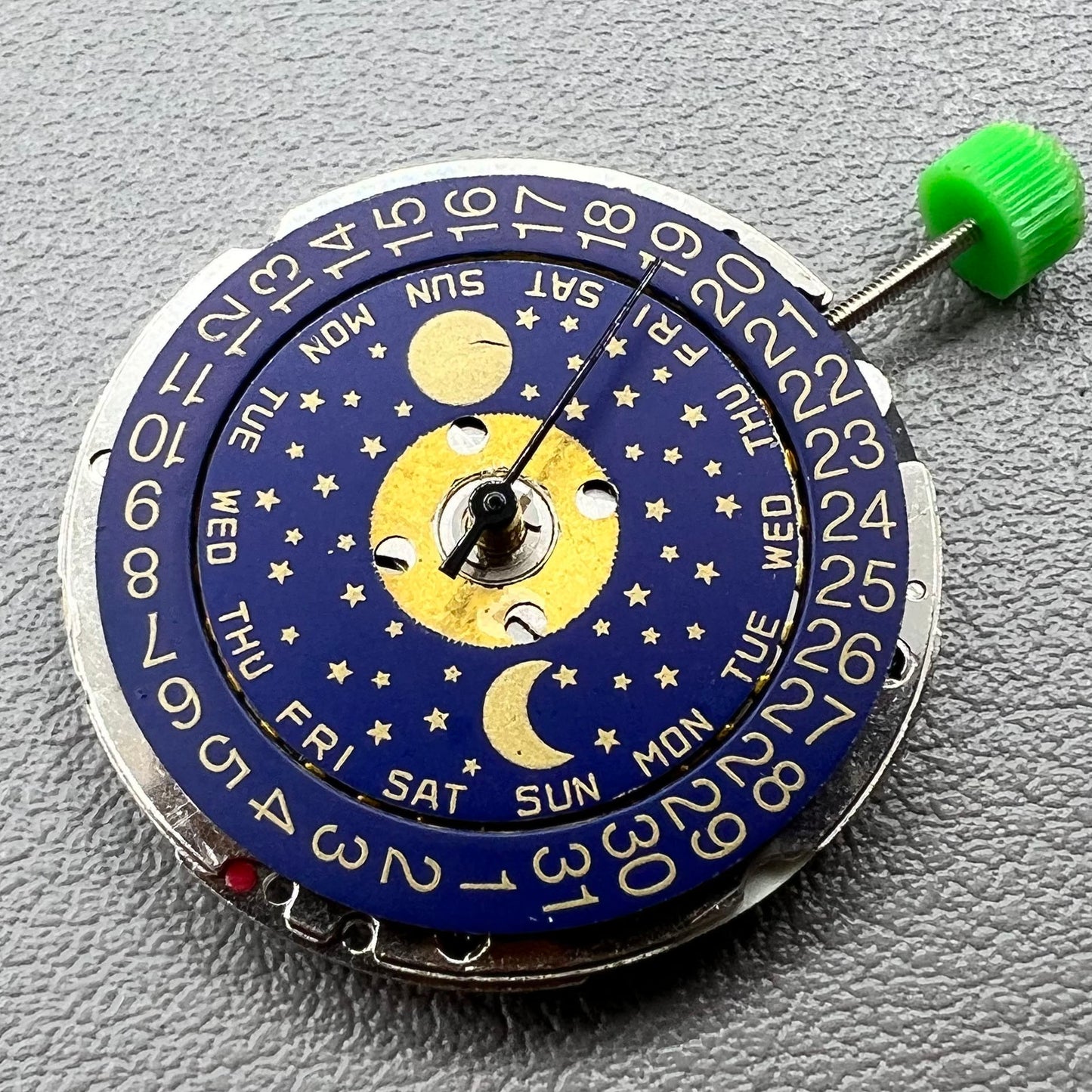 Swiss ISA 1198 quartz watch movement with day, date, and moon phase features for precise timekeeping.