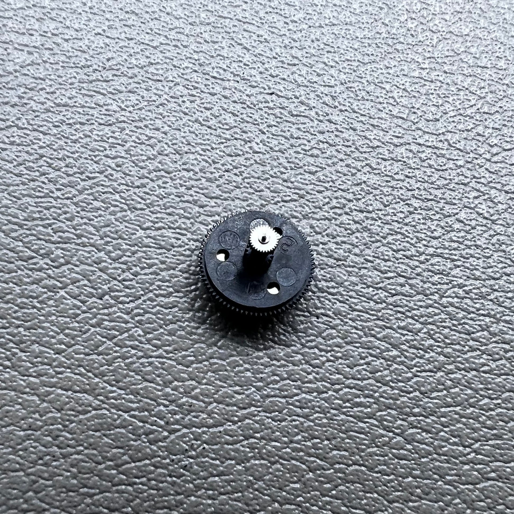 Black counting wheel for ETA C01.211 watch movement, precision replacement part for watch repair.