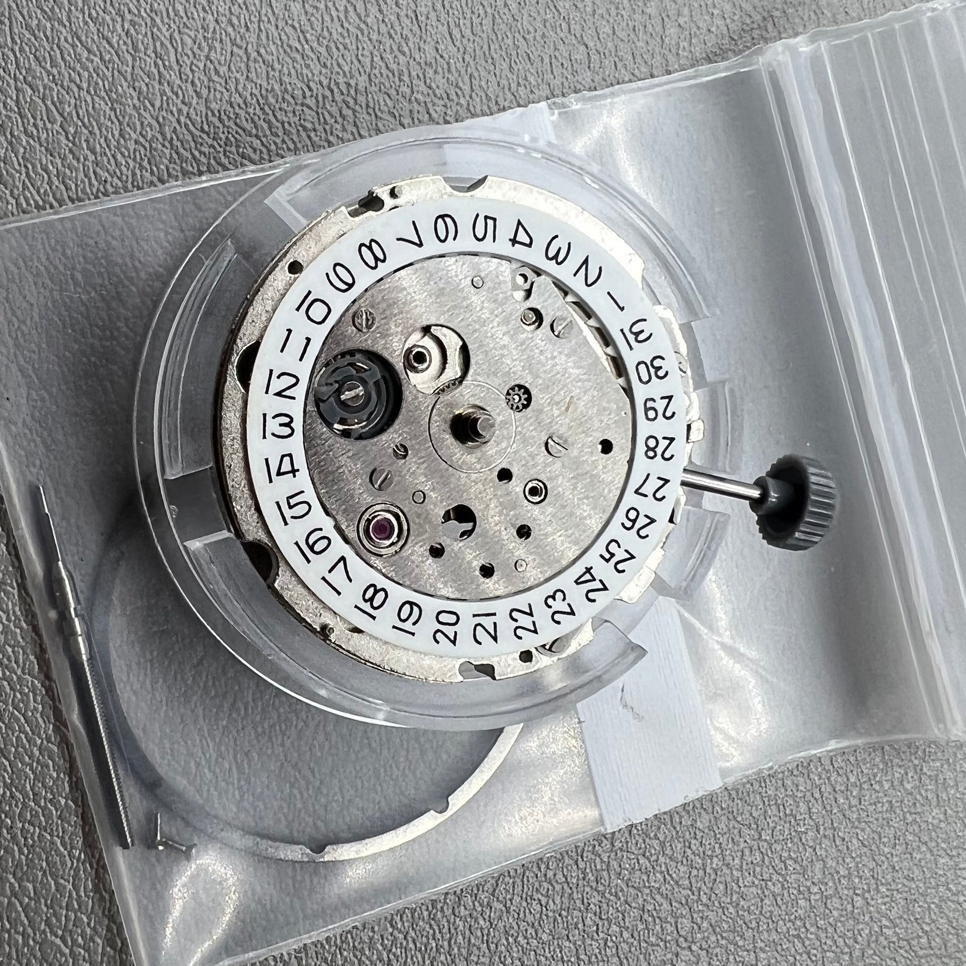 Japan Miyota 8218 automatic watch movement with date at 9 o'clock and two hands, precision timekeeping.
