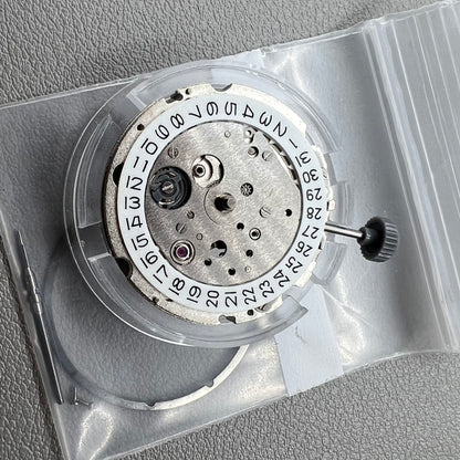 Japan Miyota 8218 automatic watch movement with date at 9 o'clock and two hands, precision timekeeping.