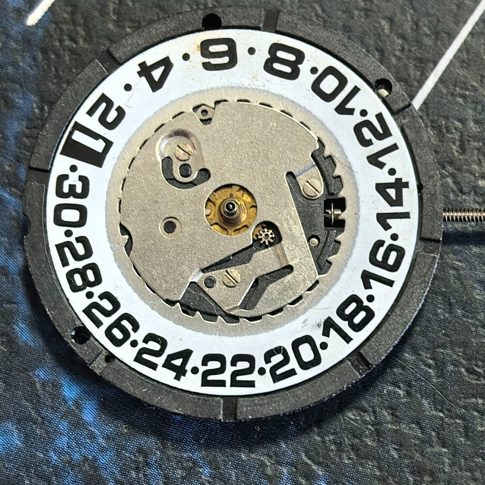 Swiss ISA 2320 quartz watch part with white dial and black font, three-hand movement