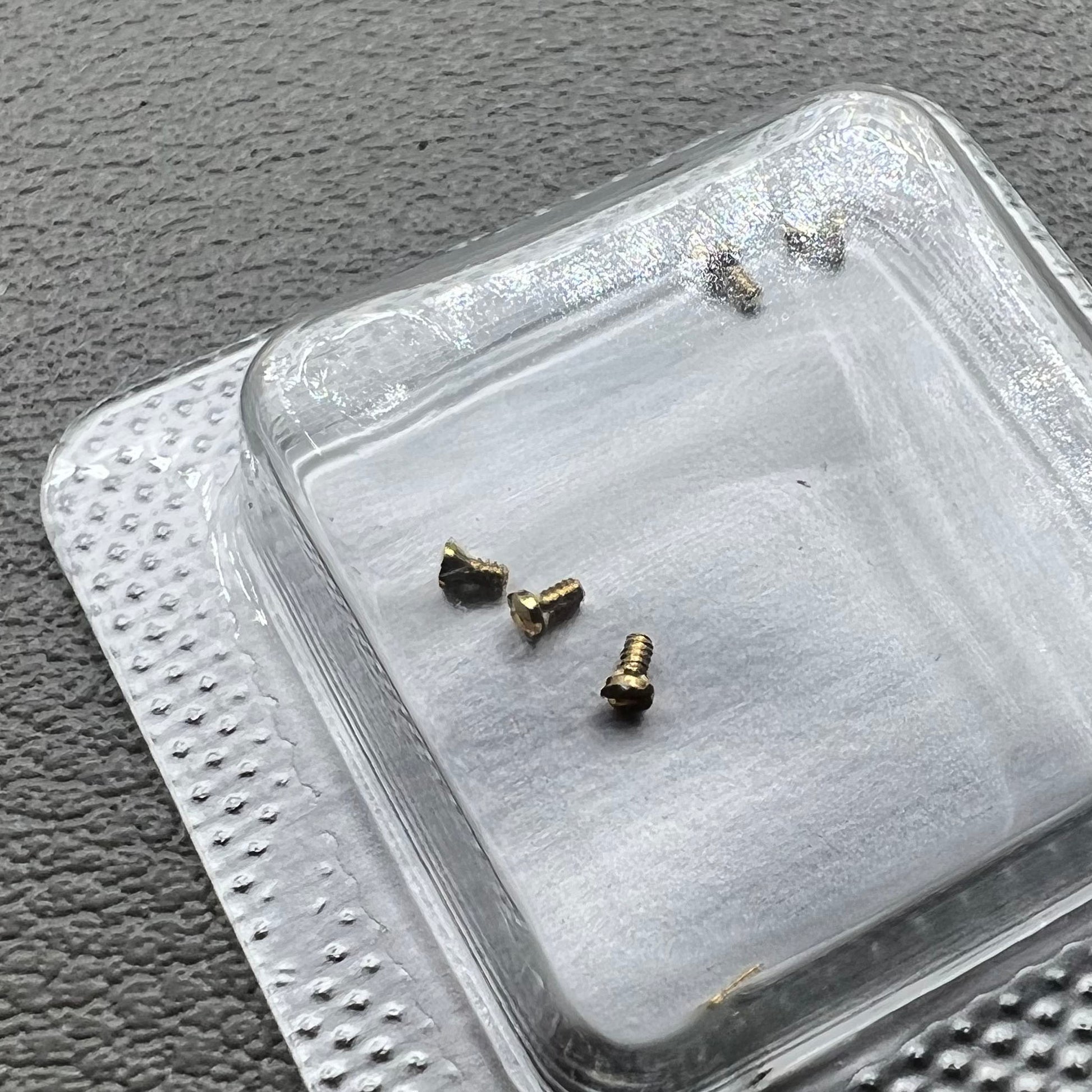 Set of 6 L4.209.4 watch case back screws, 1.2�0.7�1.7mm, for precise watch repair and maintenance.
