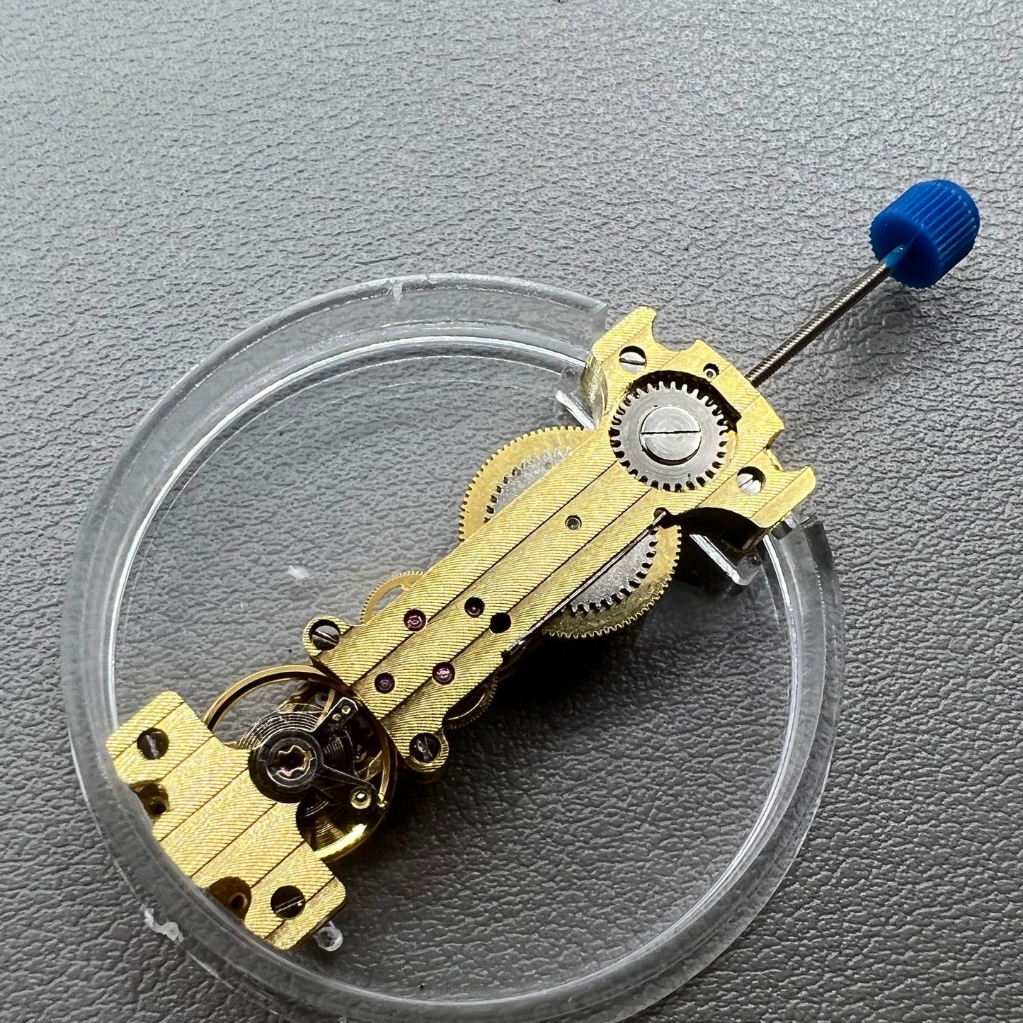Golden Long Hand winding watch movement showcasing intricate mechanical craftsmanship.