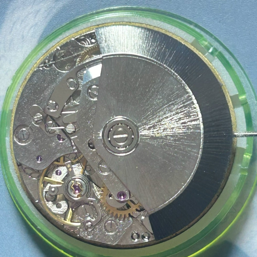 Dandong 7750 mechanical watch movement displaying 7 hands including small seconds at 6, 9, and 12 o'clock positions.
