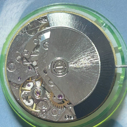 Dandong 7750 mechanical watch movement displaying 7 hands including small seconds at 6, 9, and 12 o'clock positions.
